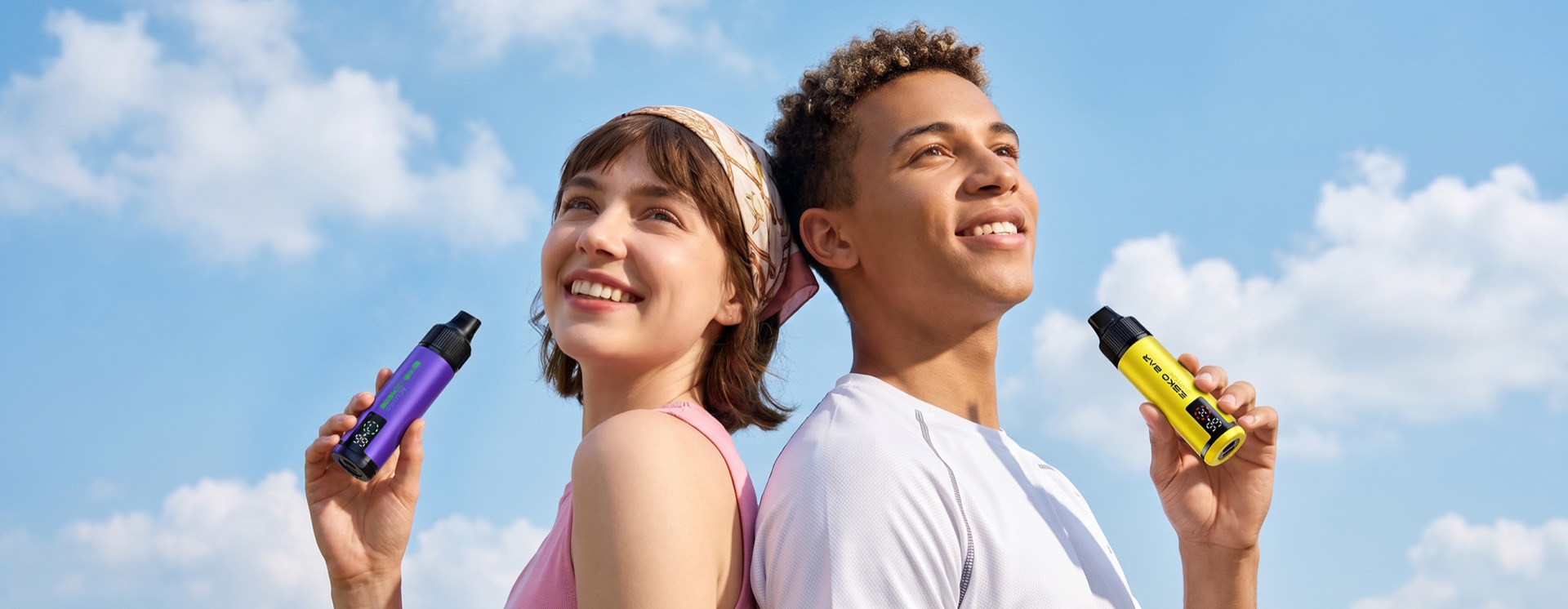 Two people outdoors with ESKO BAR devices against a bright sky